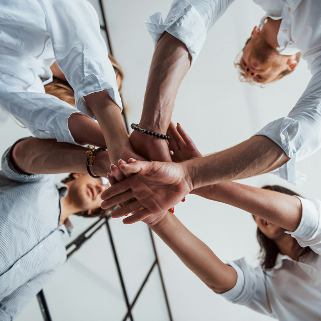 Team huddle with hands together